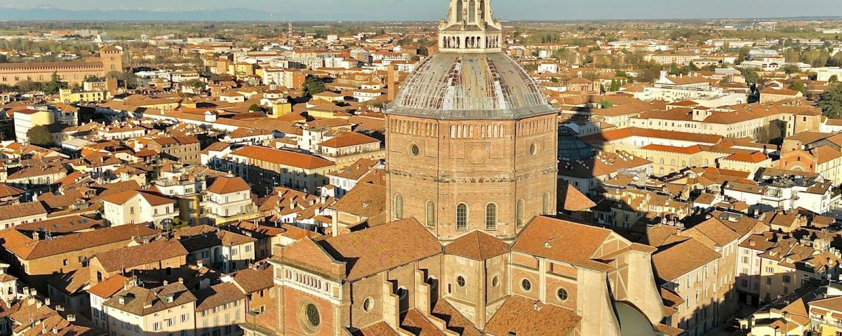 an aerial view of a city with a church tower