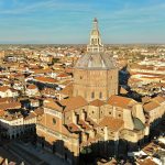 an aerial view of a city with a church tower