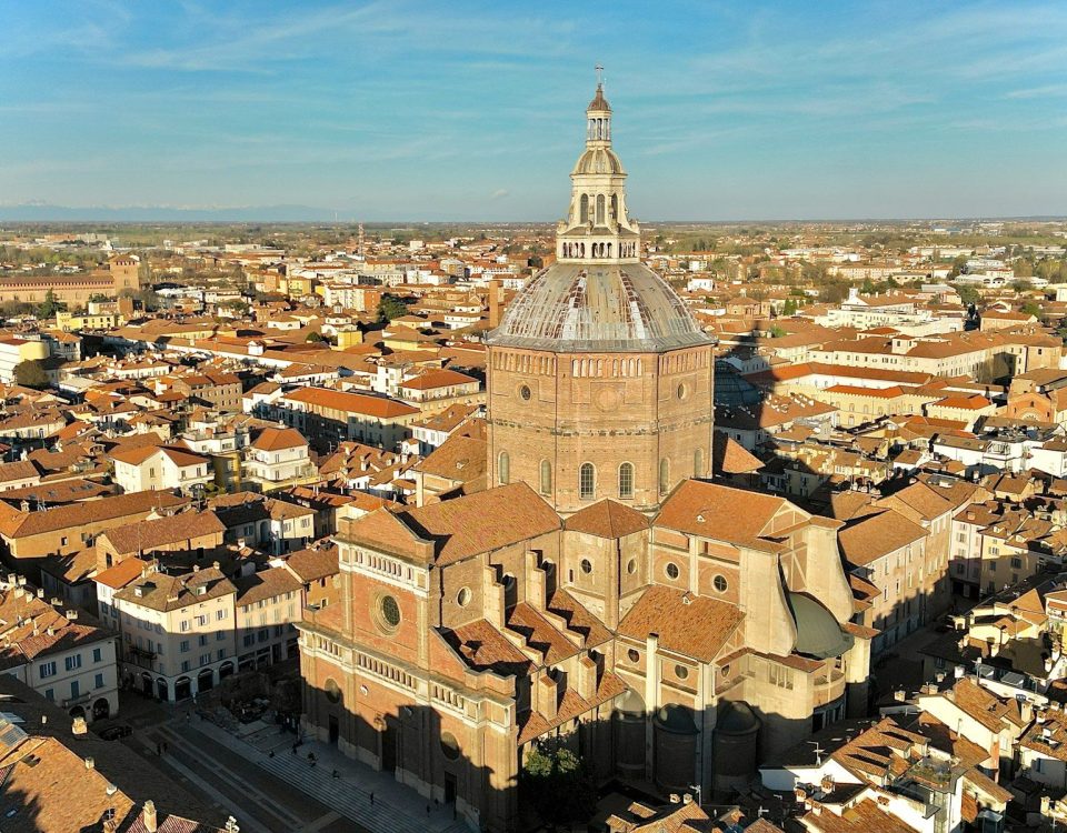 an aerial view of a city with a church tower